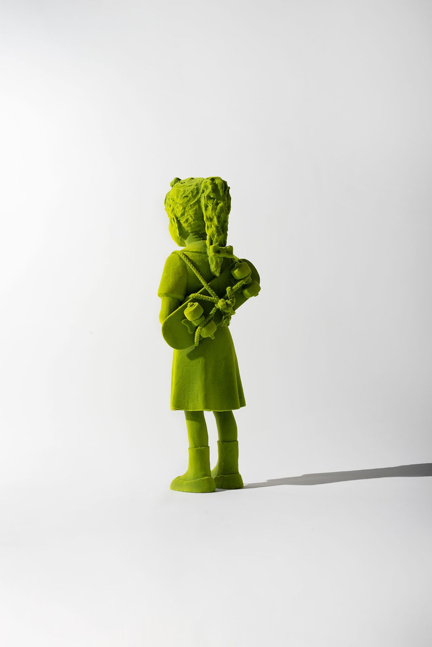 Kim Simonsson, Moss Skater Girl, 2022. Stoneware, epoxy resin, nylon fibre, and found objects. Photography courtesy of Jason Jacques Gallery and the artist.