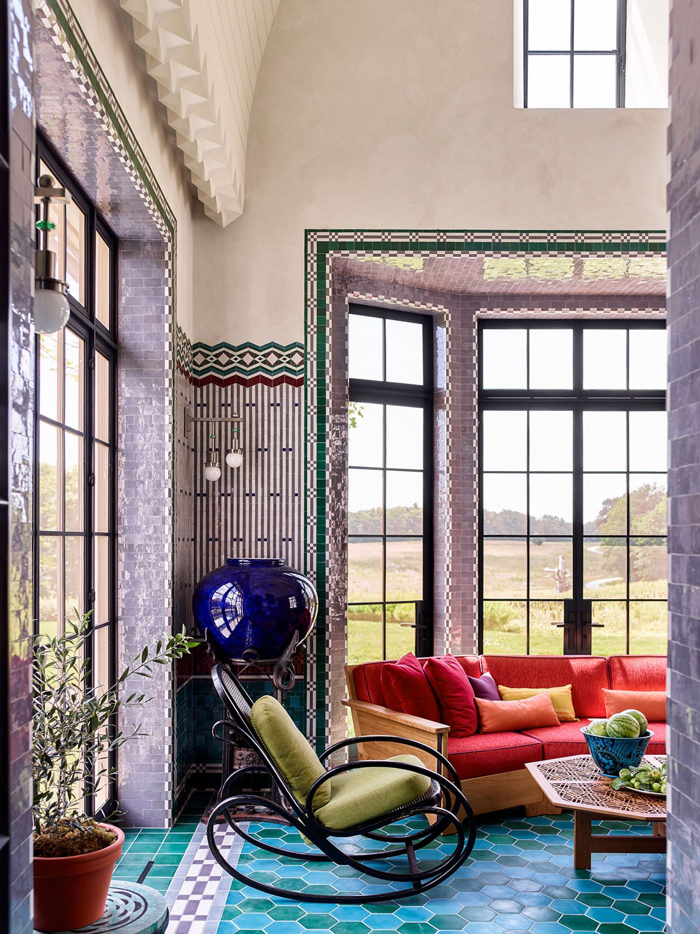 The walls of the screened porch are clad in green, burgundy, gray, and purple Moroccan zellige tiles in patterns inspired by the work of Koloman Moser and Joseph Urban.
Photography by Eric Piasecki. The walls of the screened porch are clad in green, burgundy, gray, and purple Moroccan zellige tiles in patterns inspired by the work of Koloman Moser and Joseph Urban.
Photography by Eric Piasecki.