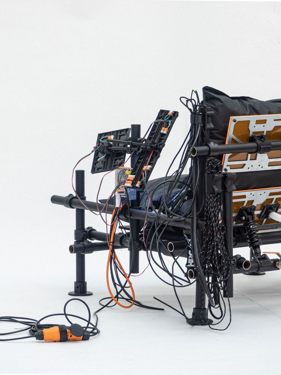 A modern chair with exposed electronics and tangled wires, showcasing a blend of industrial design and technology. A modern chair with exposed electronics and tangled wires, showcasing a blend of industrial design and technology.
