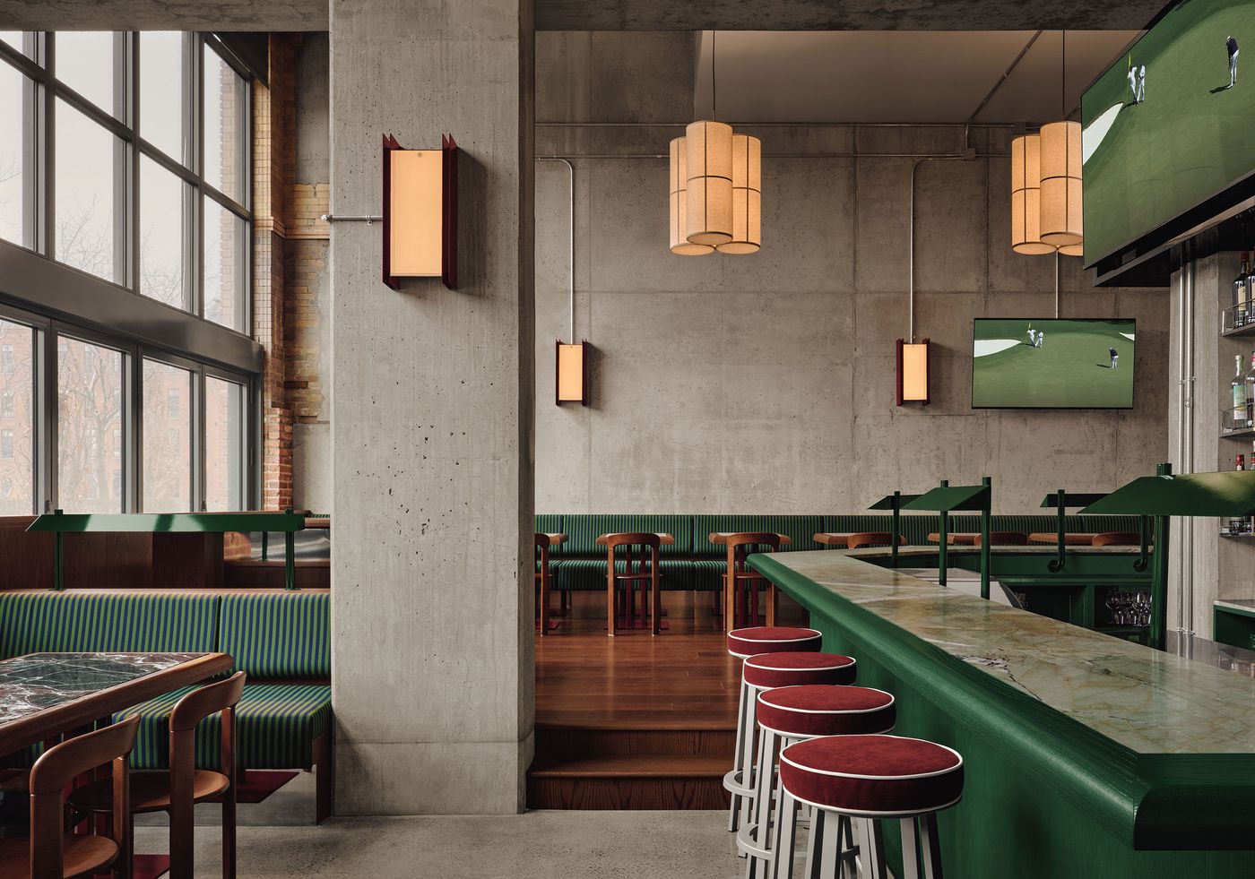 Modern bar interior with green accents, wooden furniture, large windows, and pendant lighting, featuring a TV and marble countertop. Modern bar interior with green accents, wooden furniture, large windows, and pendant lighting, featuring a TV and marble countertop.
