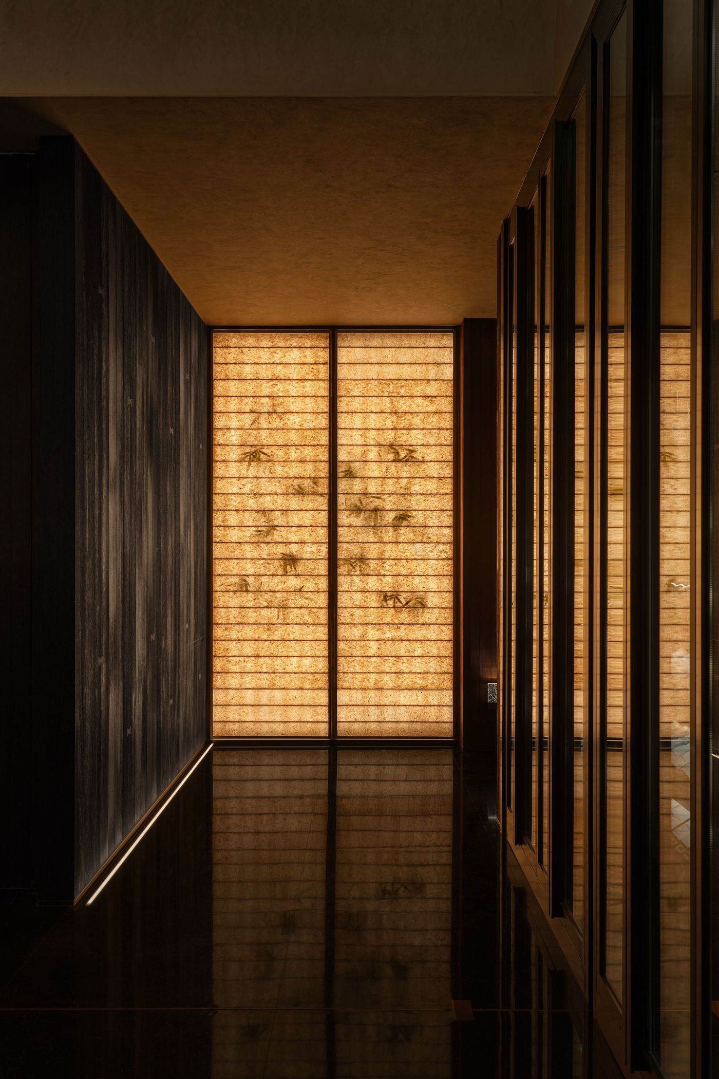 A serene hallway with warm, glowing paneling and rich, dark wood accents reflecting in the glossy floor. A serene hallway with warm, glowing paneling and rich, dark wood accents reflecting in the glossy floor.