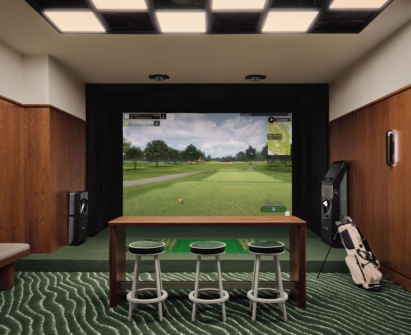 Golf simulator room featuring a large screen, green turf flooring, bar stools, and golf equipment, set in a stylish wooden ambiance. Golf simulator room featuring a large screen, green turf flooring, bar stools, and golf equipment, set in a stylish wooden ambiance.