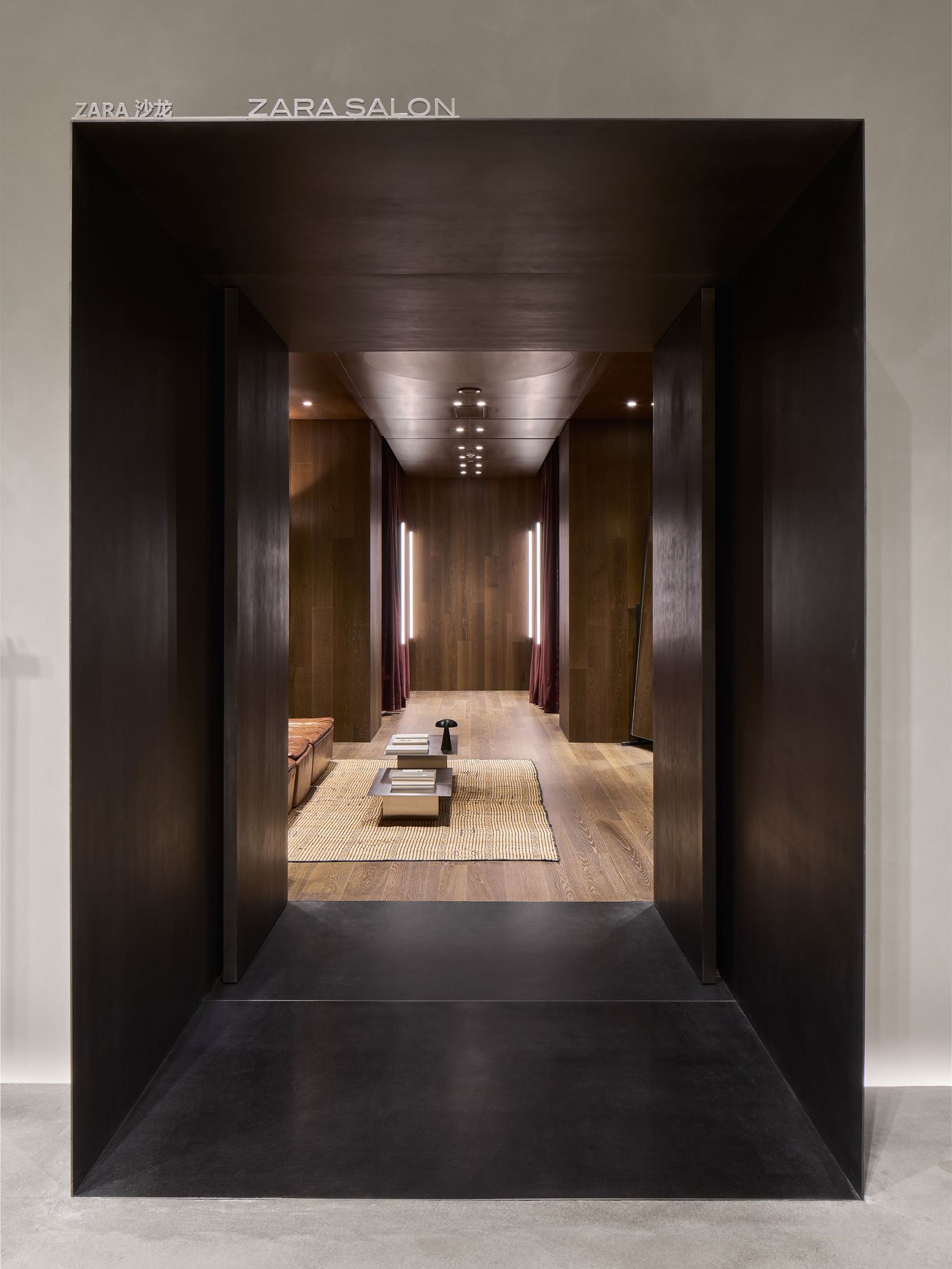 A sleek entrance to the Zara Salon, featuring dark walls, warm wooden tones, and modern lighting, inviting exploration inside. A sleek entrance to the Zara Salon, featuring dark walls, warm wooden tones, and modern lighting, inviting exploration inside.
