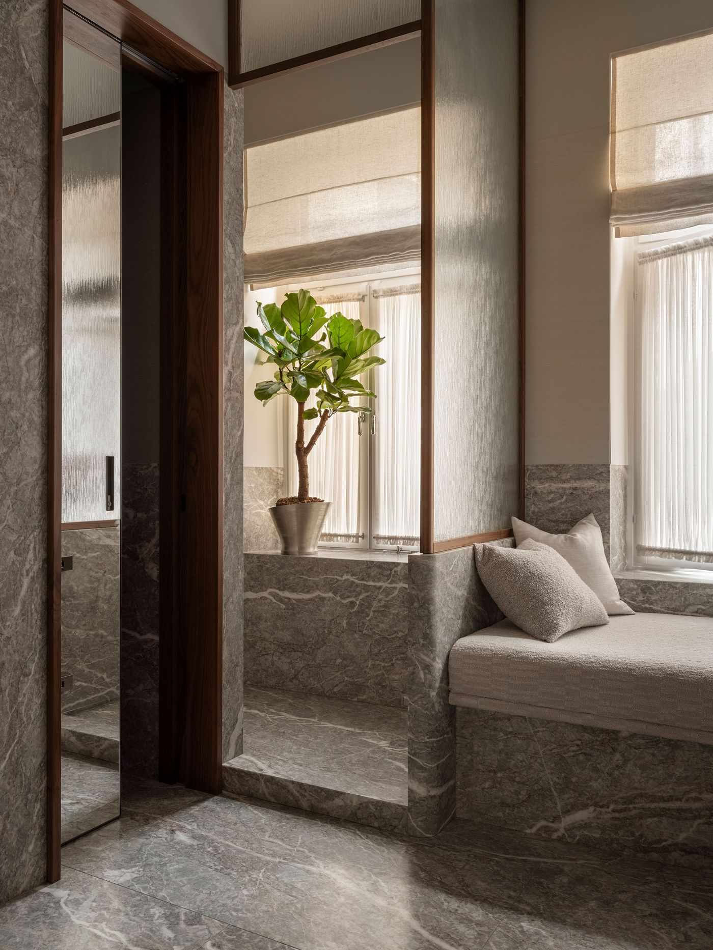 A serene interior featuring a cozy seating nook, a potted plant, and marble finishes, illuminated by soft natural light through sheer curtains. A serene interior featuring a cozy seating nook, a potted plant, and marble finishes, illuminated by soft natural light through sheer curtains.