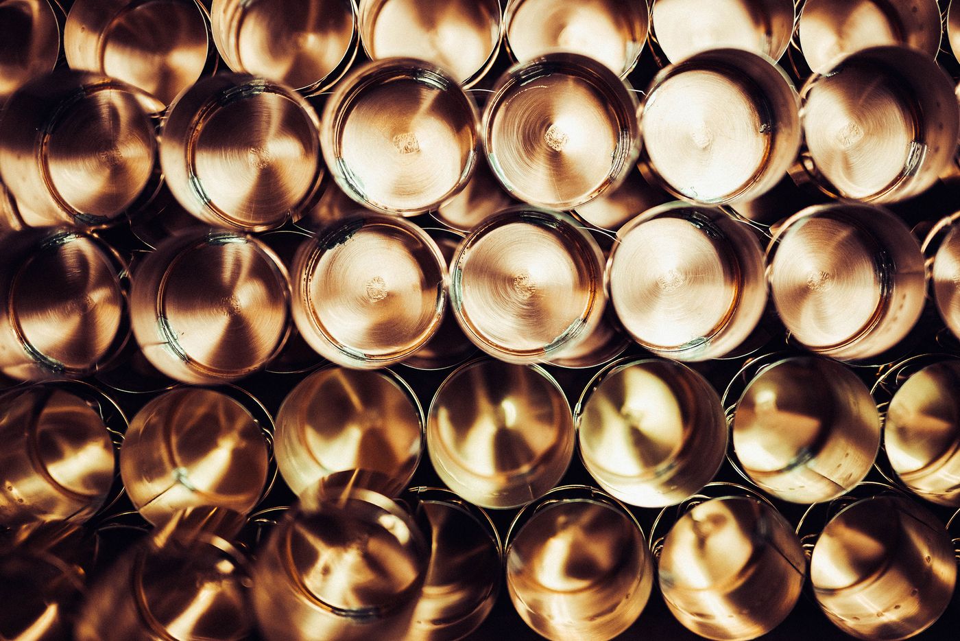 A craftsman carefully polishes a metallic object in a workshop, surrounded by tools and materials, focused on achieving a smooth finish. A craftsman carefully polishes a metallic object in a workshop, surrounded by tools and materials, focused on achieving a smooth finish.