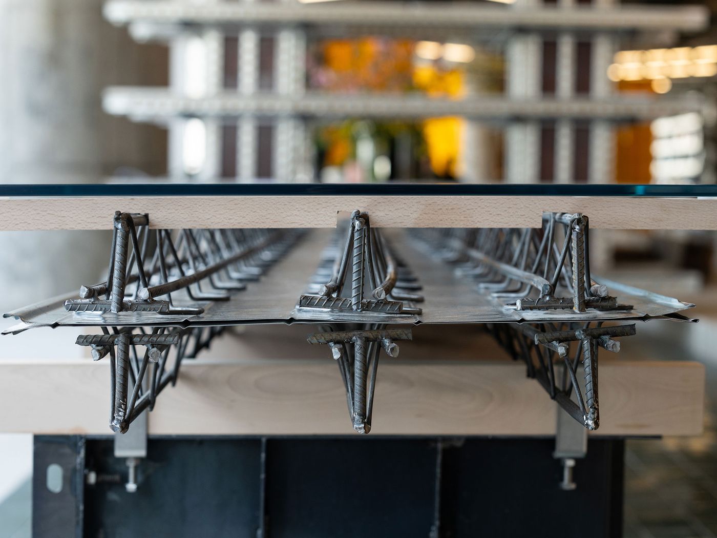 A close-up reveals the ingenious construction of a table in 889 GLO Art Space, where a clear glass top rests on exposed rebar and steel sheeting, reminiscent of construction site aesthetics. This detail showcases the space's commitment to industrial chic, transforming raw, functional materials into refined design elements. A close-up reveals the ingenious construction of a table in 889 GLO Art Space, where a clear glass top rests on exposed rebar and steel sheeting, reminiscent of construction site aesthetics. This detail showcases the space's commitment to industrial chic, transforming raw, functional materials into refined design elements.