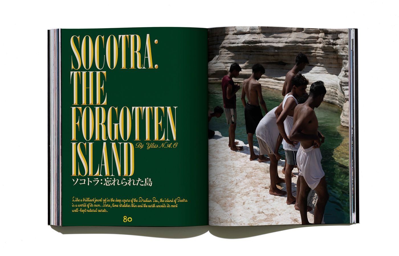 A magazine spread titled "Socotra: The Forgotten Island," featuring a group of boys near a turquoise water pool amidst rocky cliffs.