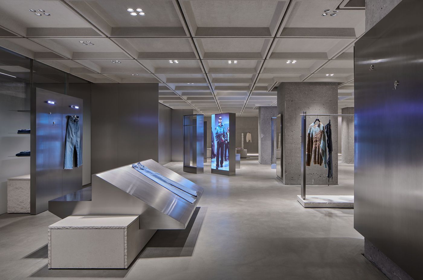 Interior of a modern clothing store featuring sleek displays, denim on mannequins, and minimalistic design elements in neutral tones. Interior of a modern clothing store featuring sleek displays, denim on mannequins, and minimalistic design elements in neutral tones.