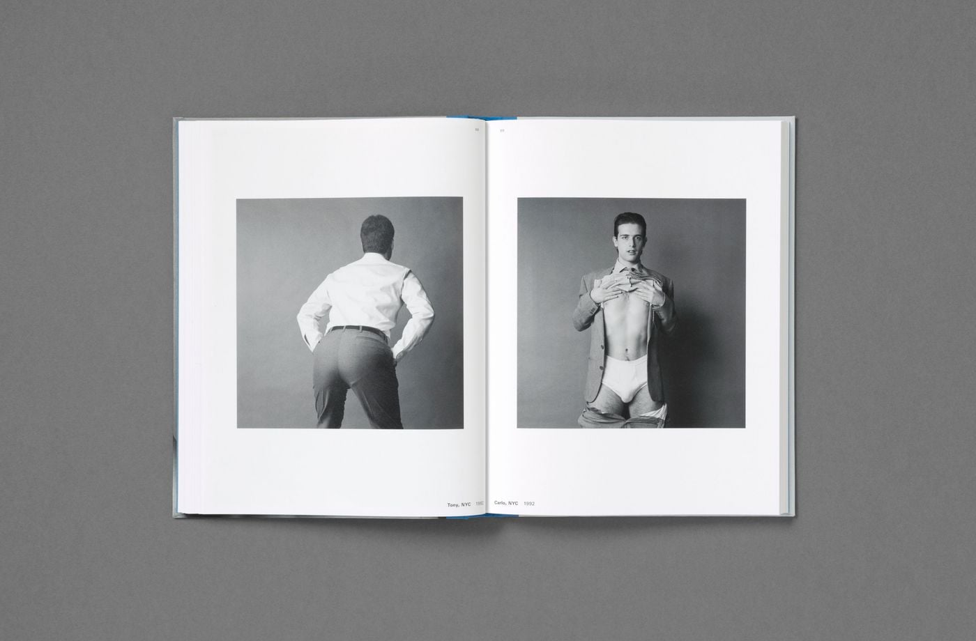 Two black-and-white studio portraits from 1992, Tony, NYC and Carlo, NYC, face each other across a spread of Don't Worry Boys. One man turns his back to the camera, hands slipped into his trouser pockets; the other, in blazer and tie, lifts his shirt over white briefs, his trousers dropped, a playful striptease of office attire. Two black-and-white studio portraits from 1992, Tony, NYC and Carlo, NYC, face each other across a spread of Don't Worry Boys. One man turns his back to the camera, hands slipped into his trouser pockets; the other, in blazer and tie, lifts his shirt over white briefs, his trousers dropped, a playful striptease of office attire.