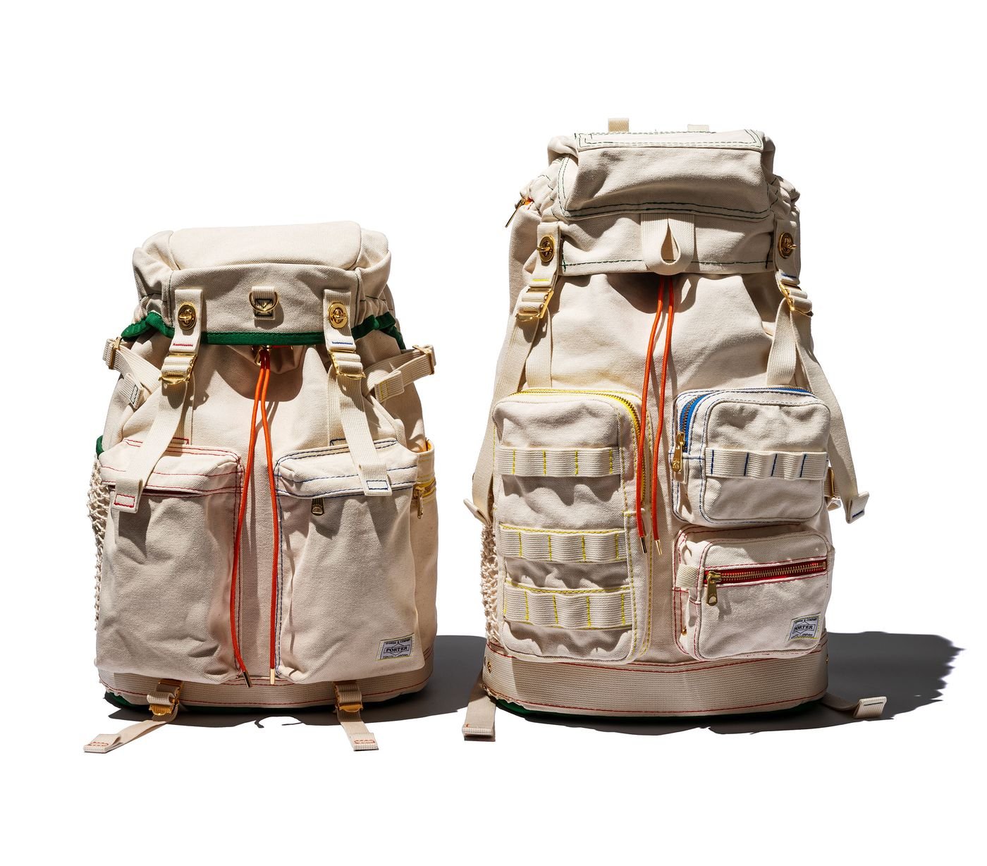 Two beige backpacks with various pockets and colorful straps, showcasing distinct designs and sizes against a white background.