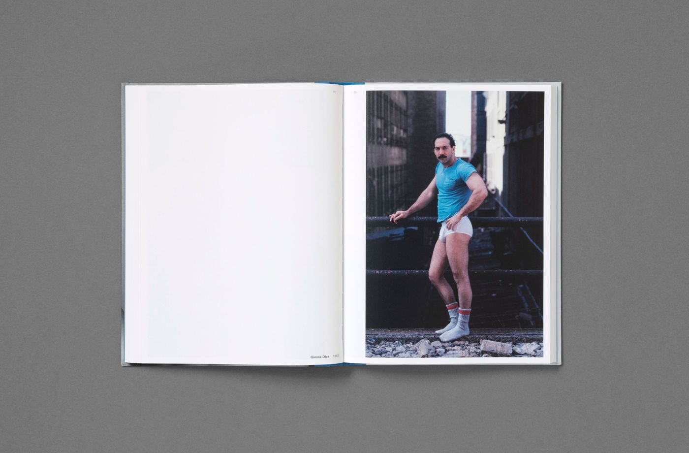A moustached man in a turquoise T-shirt, white briefs and red-striped tube socks poses with a hand on his hip against an iron railing, gravel at his feet and dark industrial facades rising behind. Set opposite a blank page in Don't Worry Boys, the 1981 colour photograph distils the era's swaggering self-presentation. A moustached man in a turquoise T-shirt, white briefs and red-striped tube socks poses with a hand on his hip against an iron railing, gravel at his feet and dark industrial facades rising behind. Set opposite a blank page in Don't Worry Boys, the 1981 colour photograph distils the era's swaggering self-presentation.