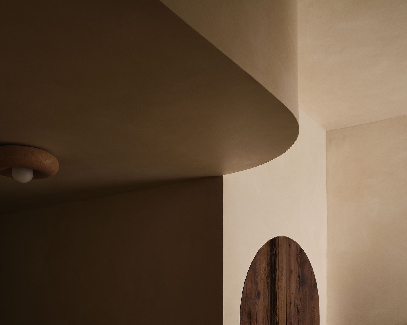 Abstract interior featuring soft, earthy tones, curved lines, and a wooden door, creating a serene and modern atmosphere. Abstract interior featuring soft, earthy tones, curved lines, and a wooden door, creating a serene and modern atmosphere.