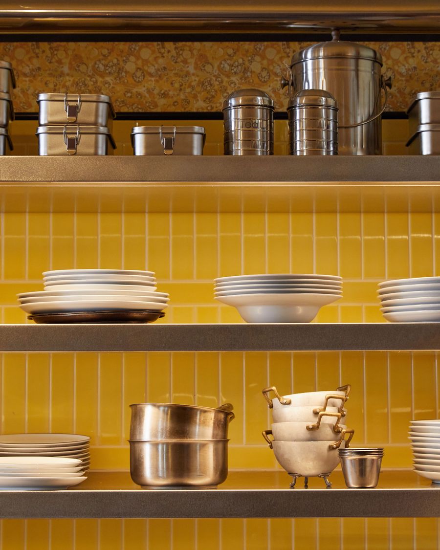 A luminous, yellow-toned display cabinet showcases a collection of polished silver coupe and dessert glasses. The warm light reflects off their curved, sculptural forms, highlighting the elegant simplicity of their design and creating a sense of refined, vintage-inspired opulence. A luminous, yellow-toned display cabinet showcases a collection of polished silver coupe and dessert glasses. The warm light reflects off their curved, sculptural forms, highlighting the elegant simplicity of their design and creating a sense of refined, vintage-inspired opulence.