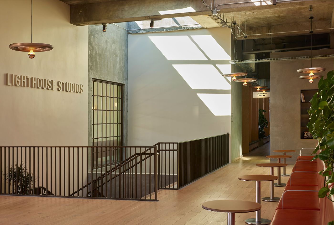 Bright, modern interior of Lighthouse Studios with minimalist decor, wooden floors, and a stylish seating area illuminated by natural light. Bright, modern interior of Lighthouse Studios with minimalist decor, wooden floors, and a stylish seating area illuminated by natural light.