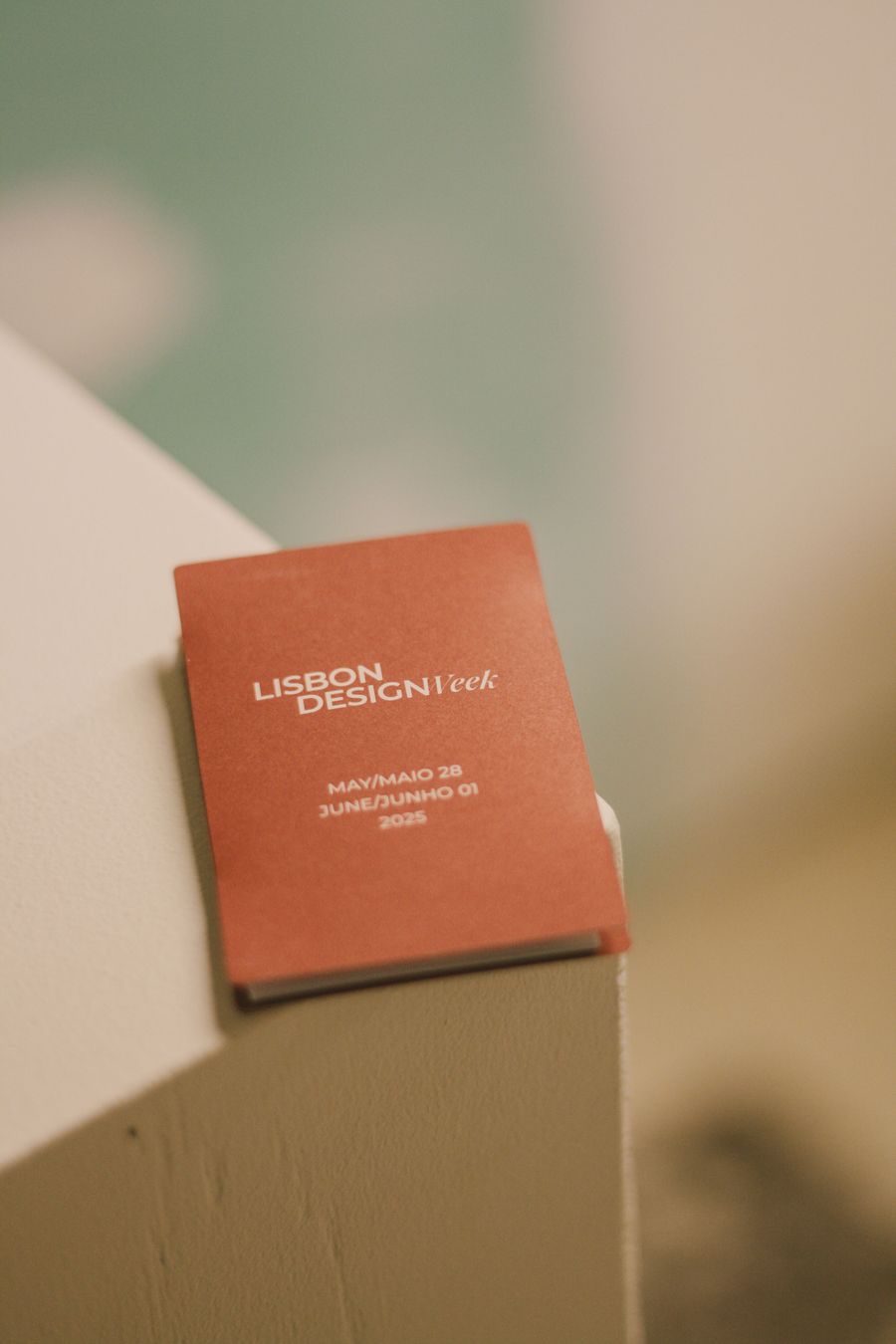 A compact, terracotta-colored program guide for Lisbon Design Week 2025 is prominently displayed on a light-colored surface. The cover, featuring clean typography, states "LISBON DESIGN Week" and "MAY/MAIO 28 JUNE/JUNHO 01 2025," signaling an event focused on contemporary design. A compact, terracotta-colored program guide for Lisbon Design Week 2025 is prominently displayed on a light-colored surface. The cover, featuring clean typography, states "LISBON DESIGN Week" and "MAY/MAIO 28 JUNE/JUNHO 01 2025," signaling an event focused on contemporary design.