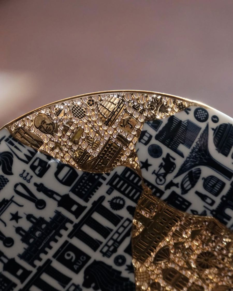 A close-up detail of the golden lattice repair seamlessly integrated into a blue-and-white patterned plate. A close-up detail of the golden lattice repair seamlessly integrated into a blue-and-white patterned plate.