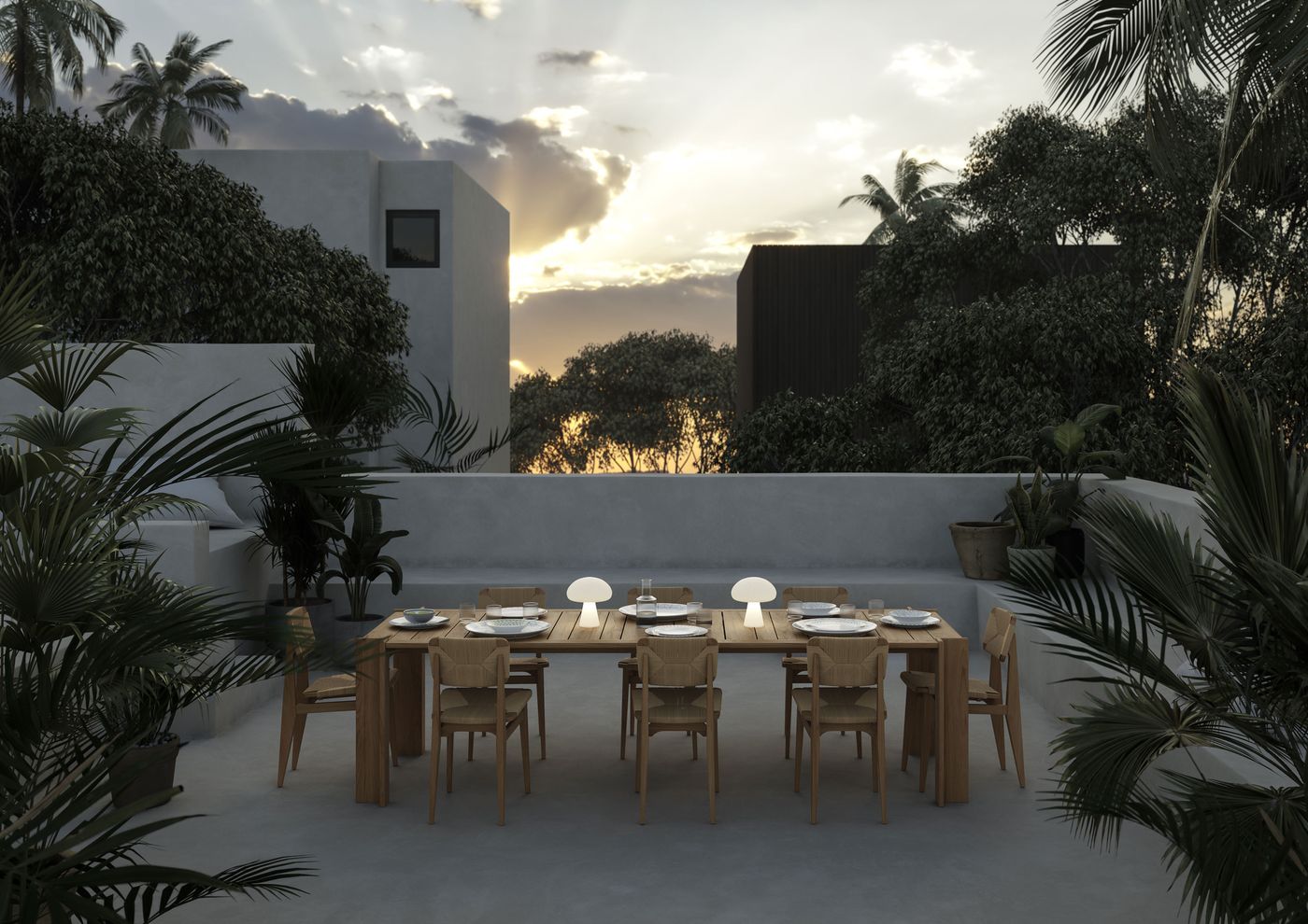 Outdoor dining scene at sunset featuring a large wooden table set for ten, with minimalist wooden chairs and three glowing mushroom-shaped table lamps by Gubi. Surrounded by lush greenery and modern concrete architecture, the setup radiates a serene, contemporary al fresco atmosphere.