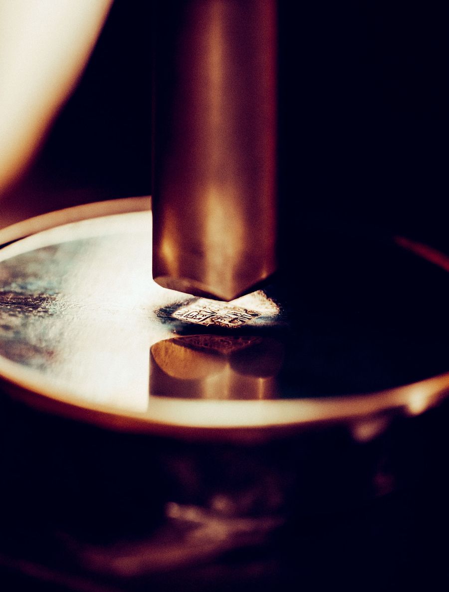 A metal stamp meets tradition—perfection pressed into time. A metal stamp meets tradition—perfection pressed into time.