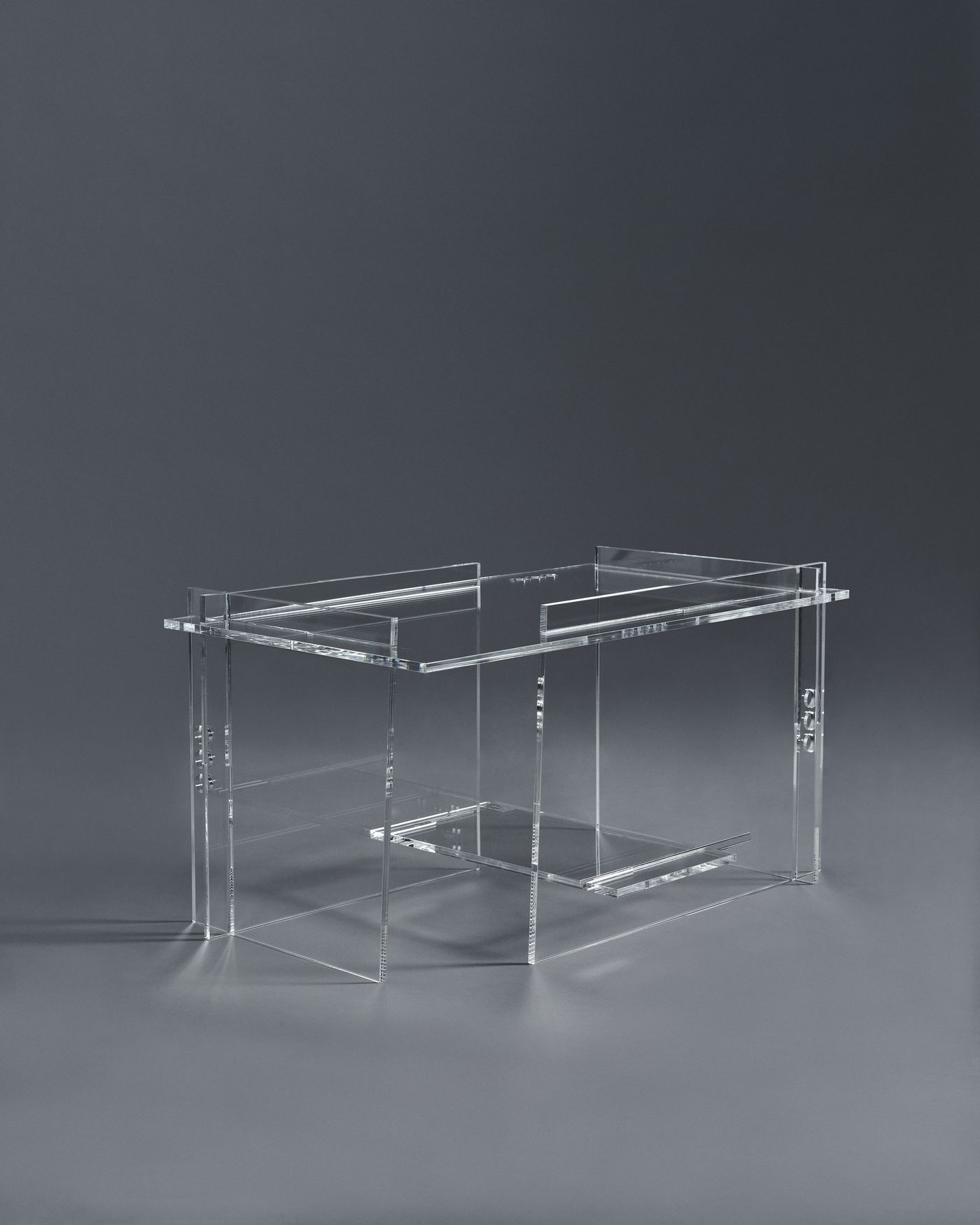 Transparent acrylic table showcasing sharp geometric precision, minimal and ethereal.