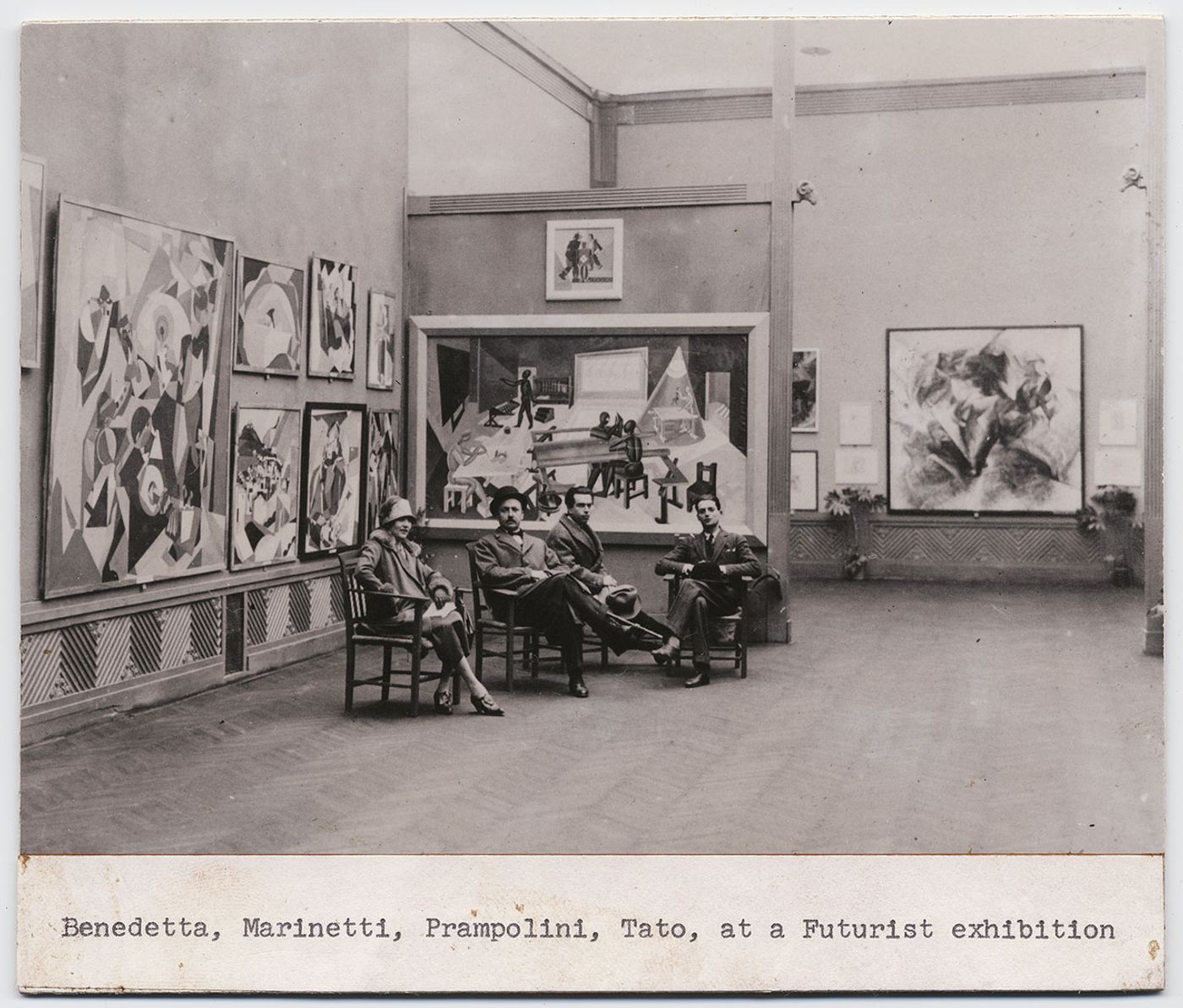 Benedetta Marinetti, Filippo Tommaso Marinetti, Enrico Prampolini and Tato at the Futurist exhibition in at Biennale di Roma in 1925. Among the exhibited works, Dinamismo di un footballer by Umberto Boccioni, 1913. Courtesy General Collection, Beinecke Rare Book and Manuscript Library, Yale University, New Haven.