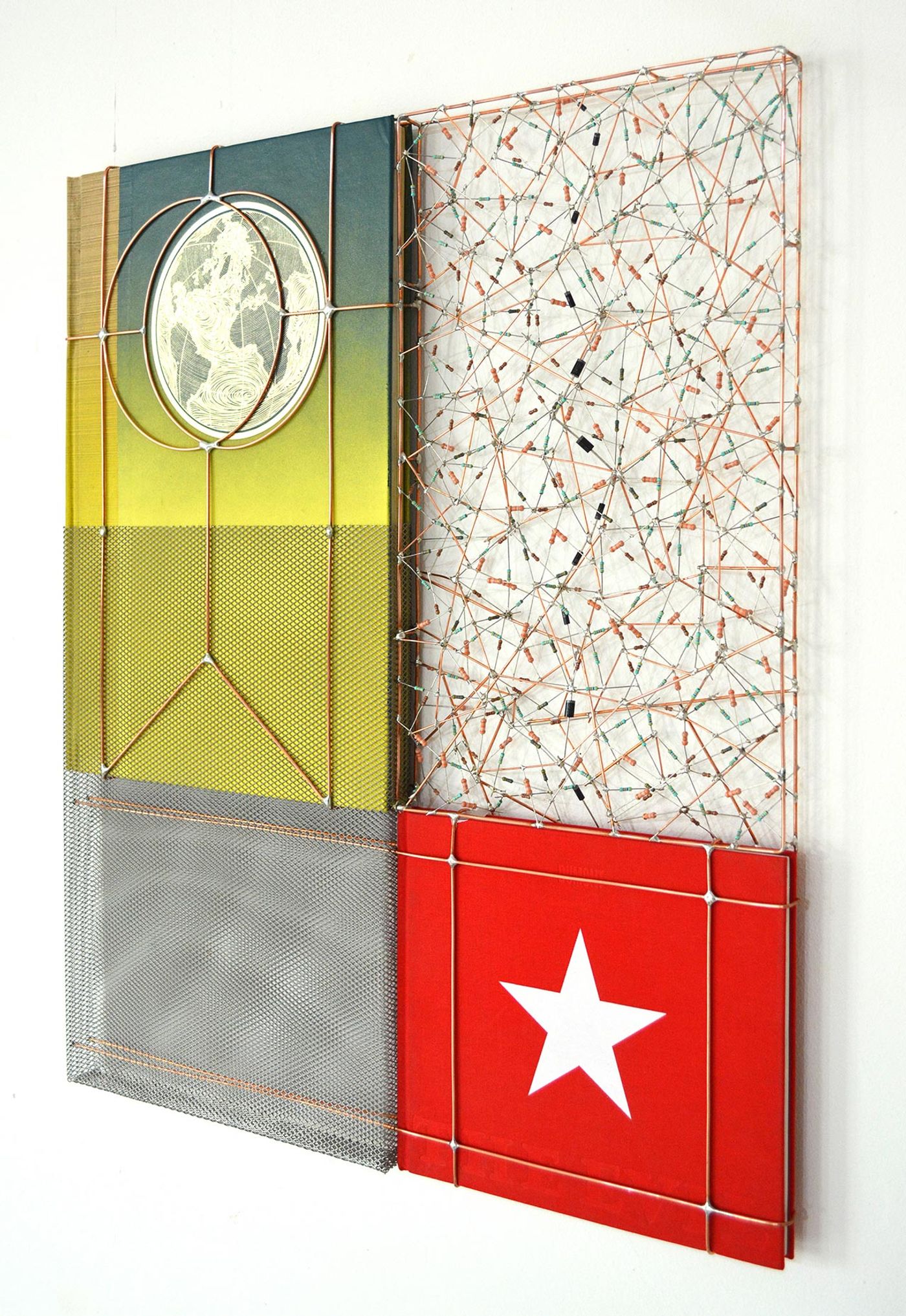 World star, 2018. Electronic components, copper wire, second hand books, steel mesh, 52x60x2,6 cm | 20½x23½x1 inches. Courtesy: The Flat – Massimo Carasi. Photo by The Flat. World star, 2018. Electronic components, copper wire, second hand books, steel mesh, 52x60x2,6 cm | 20½x23½x1 inches. Courtesy: The Flat – Massimo Carasi. Photo by The Flat.