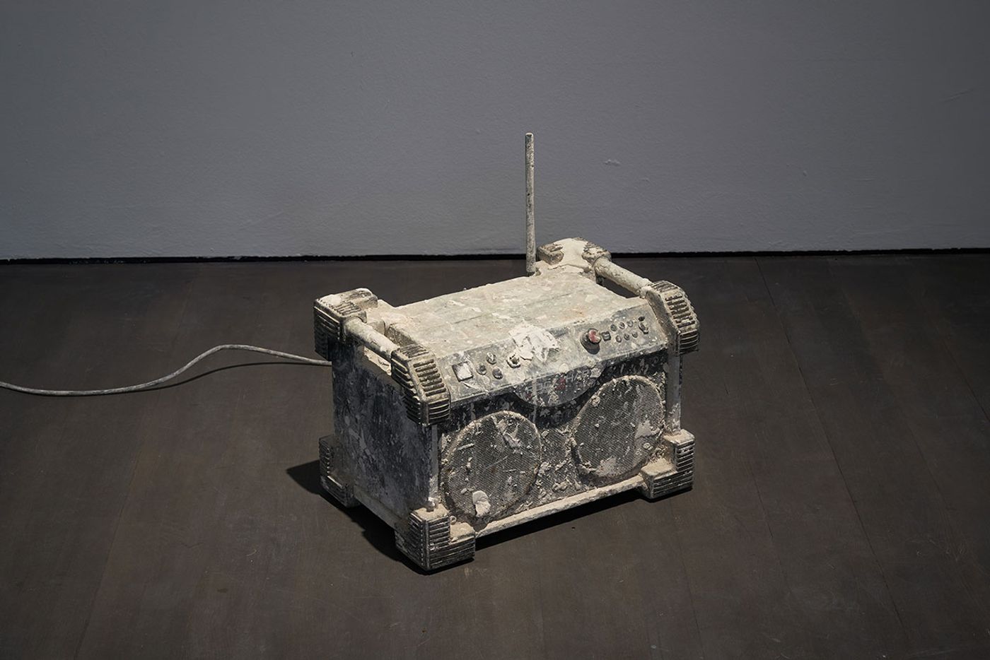 Installation view. Kris Martin, EXIT at S.M.A.K., Ghent, 2020. Photo by Dirk Pauwels.
Featured: Miserere, 2016. Radio, plaster, electronic units. König Galerie, Berlin/London/Tokyo.
Artist's statement: A robust radio from a building site, which typically blasts loud music, emits an almost inaudible version of Allegri’s Miserere." Installation view. Kris Martin, EXIT at S.M.A.K., Ghent, 2020. Photo by Dirk Pauwels.
Featured: Miserere, 2016. Radio, plaster, electronic units. König Galerie, Berlin/London/Tokyo.
Artist's statement: A robust radio from a building site, which typically blasts loud music, emits an almost inaudible version of Allegri’s Miserere."