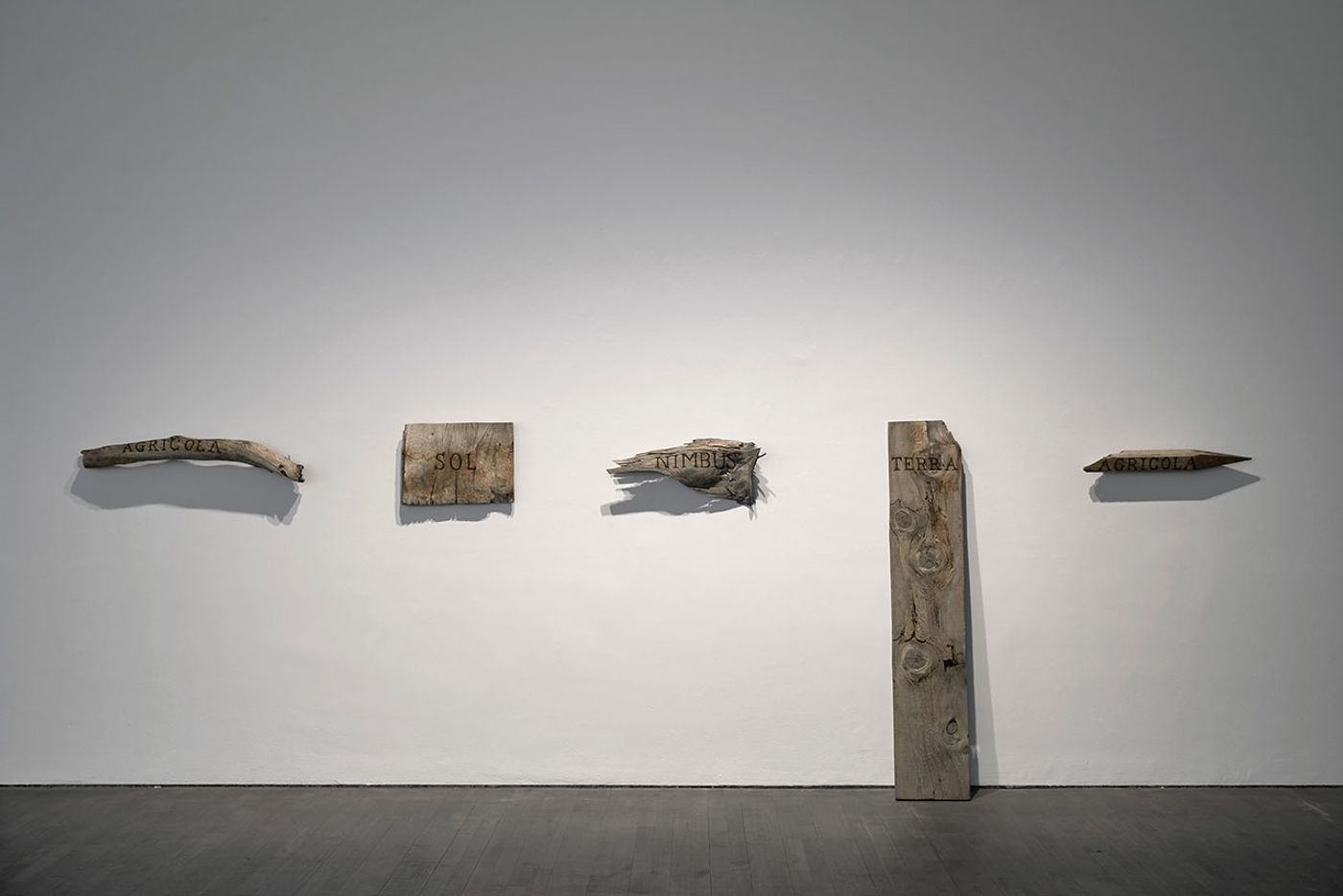Installation view. Kris Martin, EXIT at S.M.A.K., Ghent, 2020. Photo by Dirk Pauwels.
Feaured: Sol, 2006. Sunlight on wood. Collection Mimi & Filiep Libeert, Belgium.
Artist's statement: An ancient Asian folk tale tells of a farmer who wants to become the sun because it burns him. When a cloud then blocks its rays, the sun wants to become a cloud. In an actof hubris, the cloud unleashes a deluge, and the earth below begins to blossom and flourish. In his lust for power, he then wants to become the earth. Until a peasant tears up the soil with a plough, which then makes him want to become a farmer again. Installation view. Kris Martin, EXIT at S.M.A.K., Ghent, 2020. Photo by Dirk Pauwels.
Feaured: Sol, 2006. Sunlight on wood. Collection Mimi & Filiep Libeert, Belgium.
Artist's statement: An ancient Asian folk tale tells of a farmer who wants to become the sun because it burns him. When a cloud then blocks its rays, the sun wants to become a cloud. In an actof hubris, the cloud unleashes a deluge, and the earth below begins to blossom and flourish. In his lust for power, he then wants to become the earth. Until a peasant tears up the soil with a plough, which then makes him want to become a farmer again.