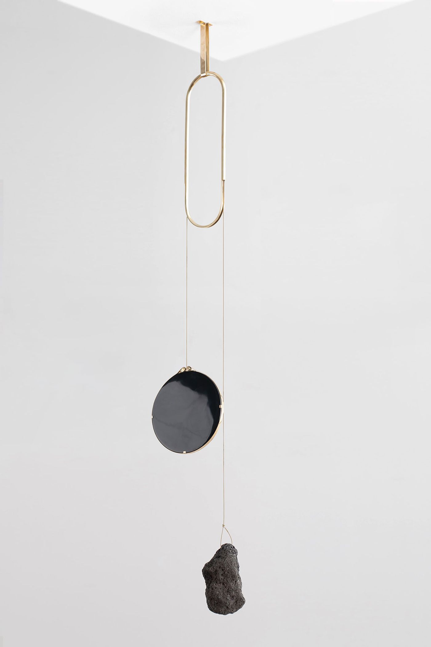 Formafantasma: Andrea Trimarchi and Simone Farresin for Gallery Libby Sellers, Iddu mirror, from De Natura Fossilium collection, 2014, Obsidian mirror, lava rock, brass, 150 × 40 cm (59 1/16 × 15 3/4 in.) © Studio FormaFantasma. 