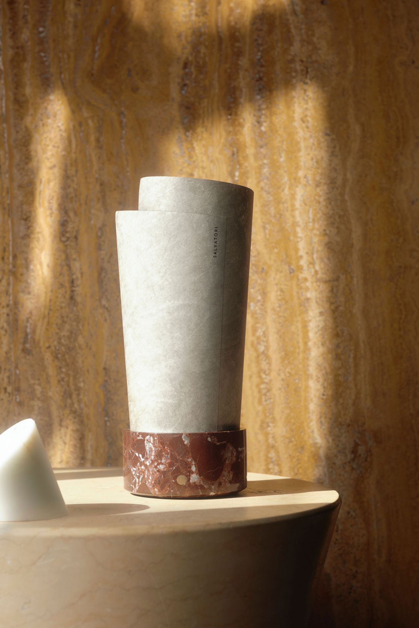 A bold composition of earthy red marble and pale parchment-like material, radiating timeless elegance.